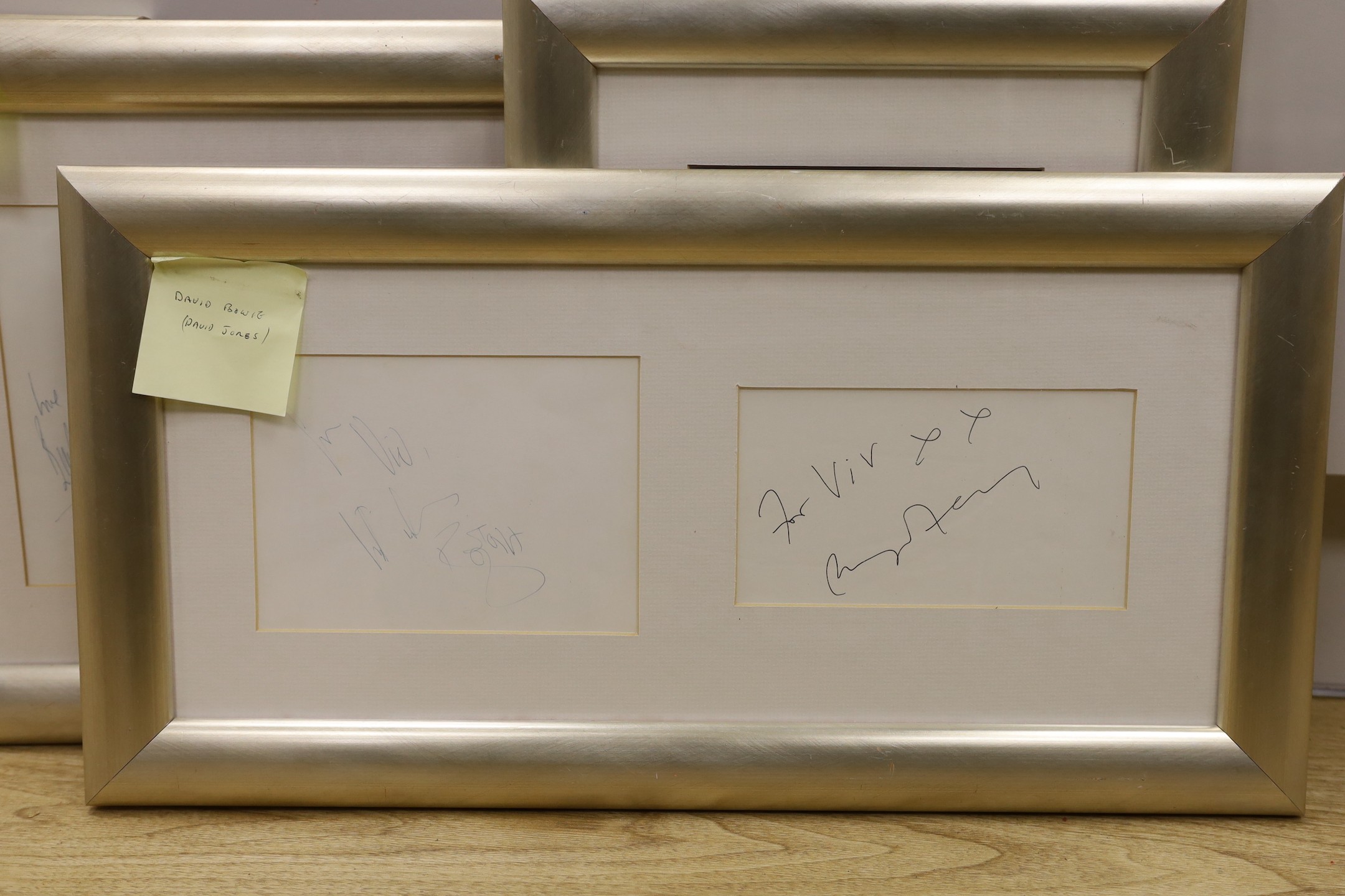 A collection of mostly framed autographs to include an event card from Elton John, 25 March 1994 signed by Charlie Watts, Jerry Hall and Jerry Hall, together with autographs by David Bowie, Phil Collins, David Bailey, Da